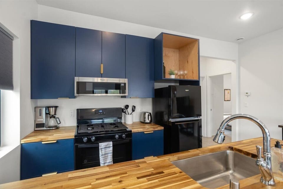Beautiful wood counters and modern kitchen, fully stocked for enjoying a meal in should you wish to enjoy a meal in. 