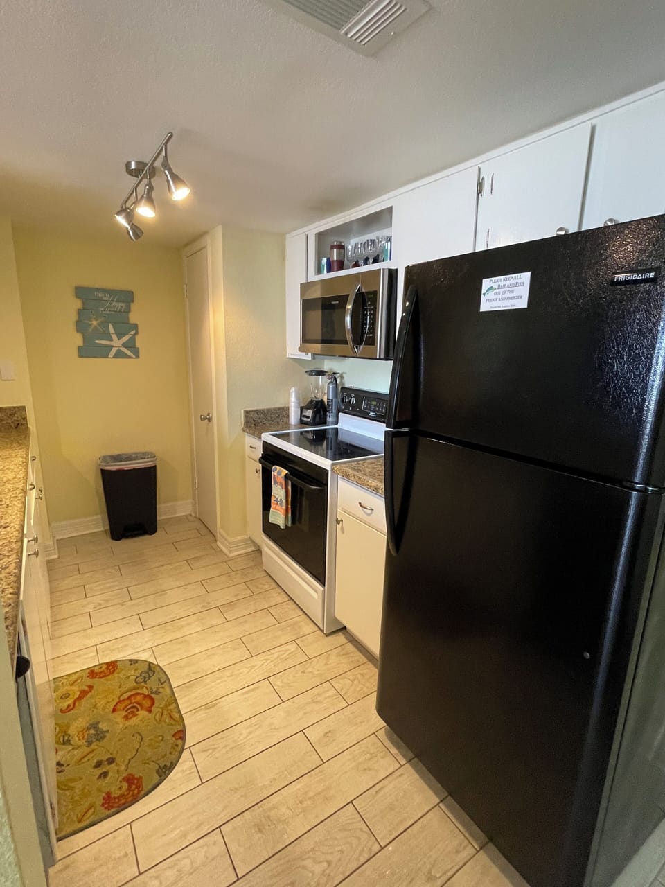 Full size appliances on this side of kitchen with panty.