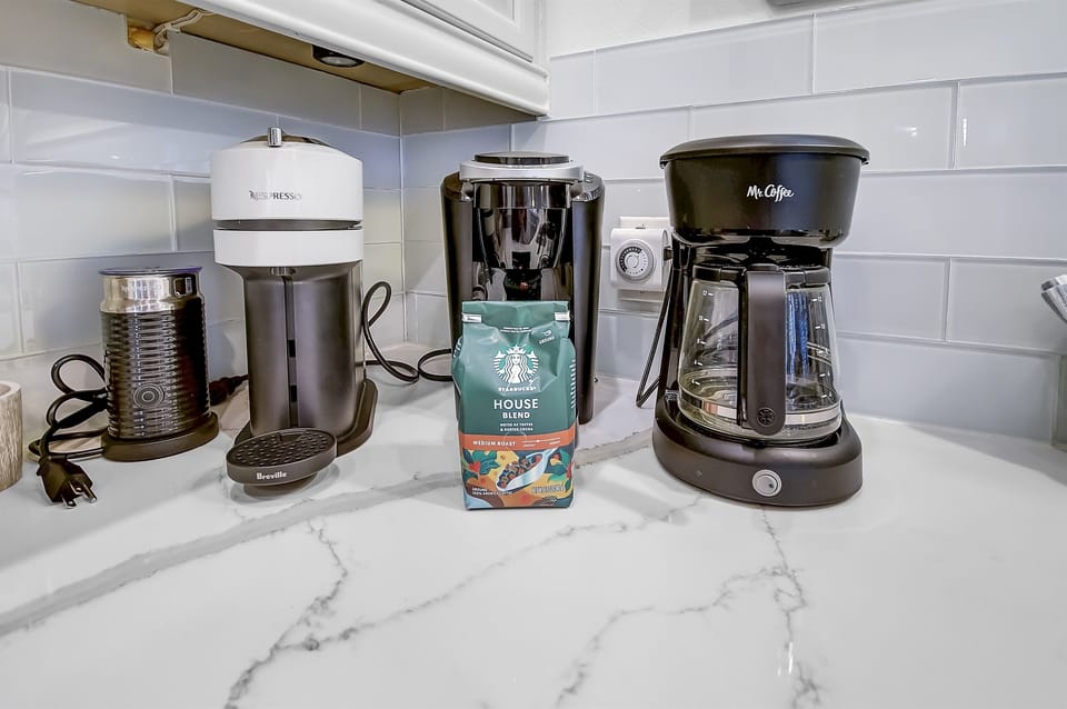 Coffee Bar - This house is equipped with a Keurig coffee maker, regular coffee pot, Nespresso machine and coffee ensuring you have access to your favorite brews with a selection of coffee pods available.