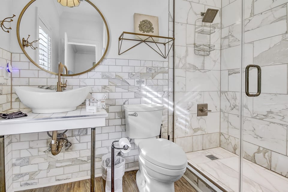 Second Floor Private Bathroom-Experience luxury in the second-floor king bedroom featuring an attached, private bathroom. Indulge in modern comfort with our updated walk-in shower, boasting sleek finishes and contemporary touches.