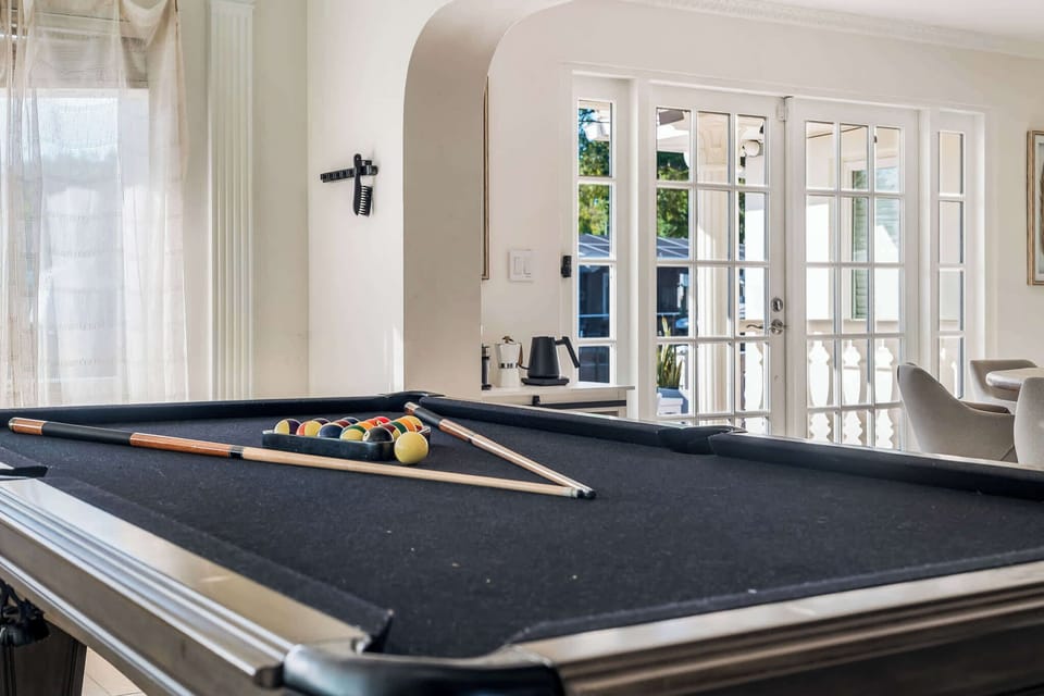 The pool table complements the room's spacious layout, providing an ideal spot for socializing and entertainment.