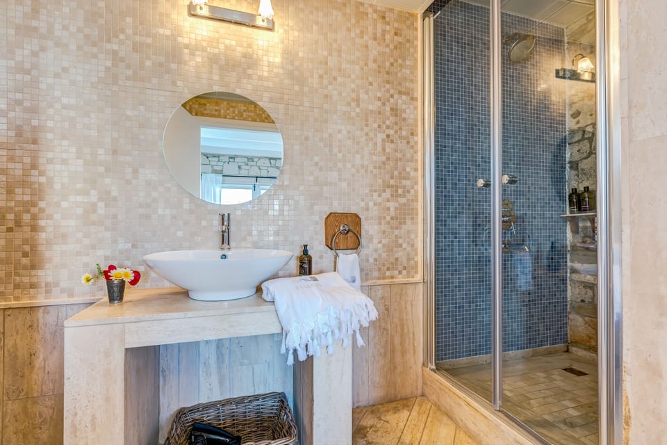 Shower, designer toiletries, hair dryer, bathrobes