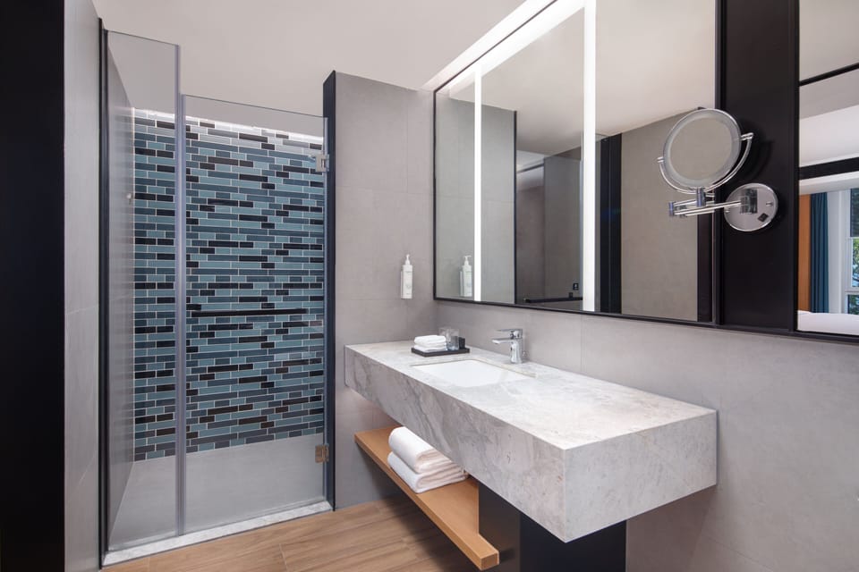 Suite, 1 King Bed, Garden View | Bathroom | Shower, rainfall showerhead, hair dryer, slippers