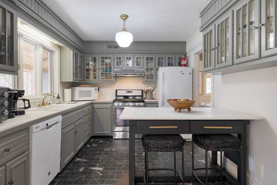 At the heart of the kitchen stands a magnificent wooden island.