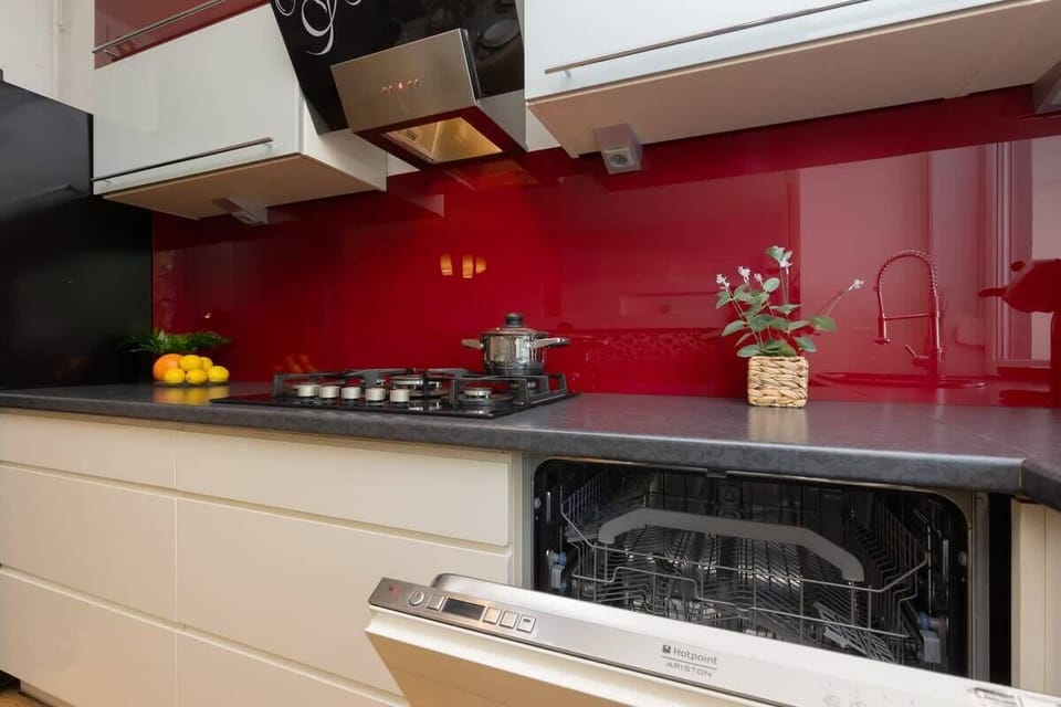 Another angle of the kitchen showing the efficient layout with ample storage and counter space, blending style with practicality.

