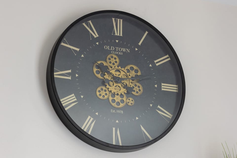 A decorative clock with Roman numerals and intricate details, adding a vintage touch to the modern interior.

