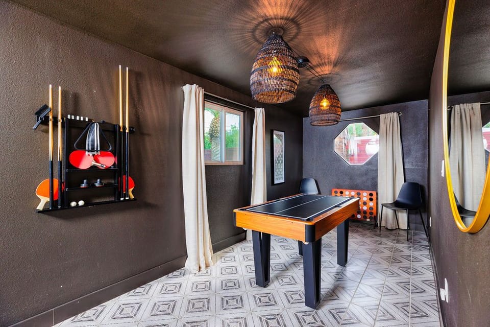 This stylish game room offers billiard cues, table tennis paddles, and other gaming essentials. 