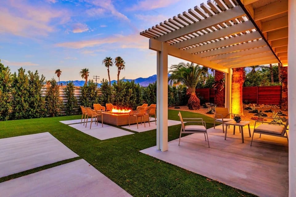 The covered patio provides a shaded retreat with cozy seating and firepit next to it. 