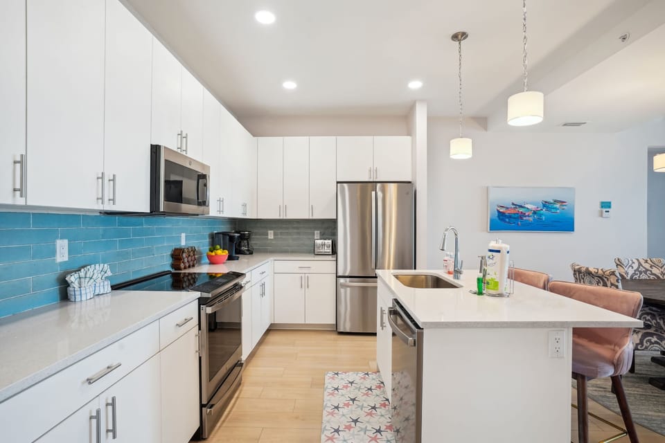 Open kitchen with stainless appliances and beautiful countertops