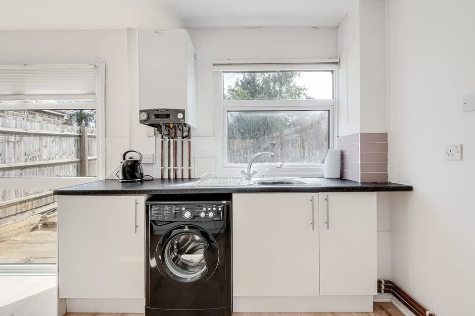 A sleek, modern kitchen fully equipped with everything you need, plus a cosy dining table with 3 chairs for enjoying your meals or casual conversations