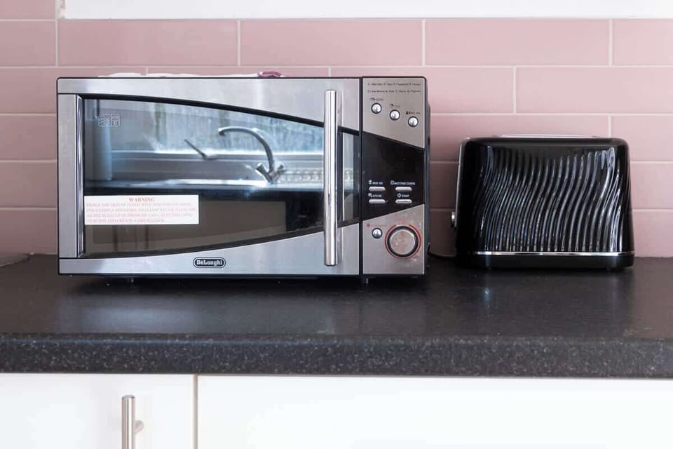 A sleek, modern kitchen fully equipped with everything you need, plus a cosy dining table with 3 chairs for enjoying your meals or casual conversations