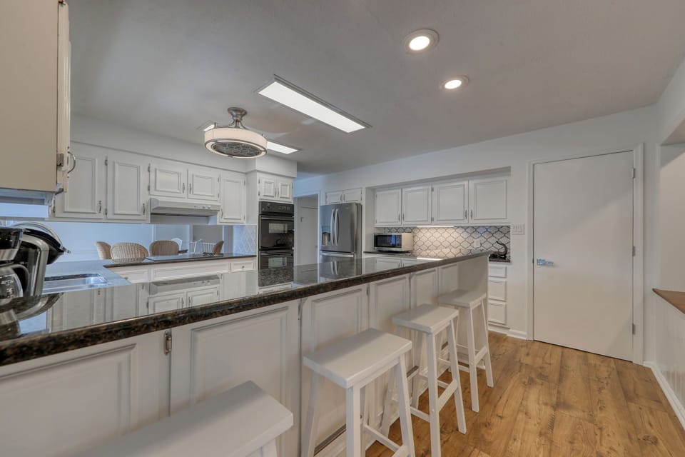 Kitchen bar and island offer plenty of seating for a quick snack