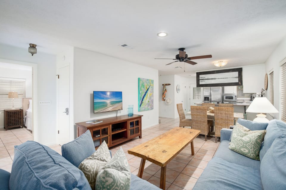 Sink into the soft blue sofa and enjoy your favorite shows on the flat-screen TV in this bright, coastal-themed living space.
