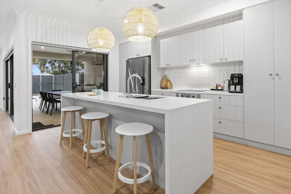 Fully equipped kitchen with features like stone benchtops, large fridge with plumbed water and ice maker, fully automated coffee machine