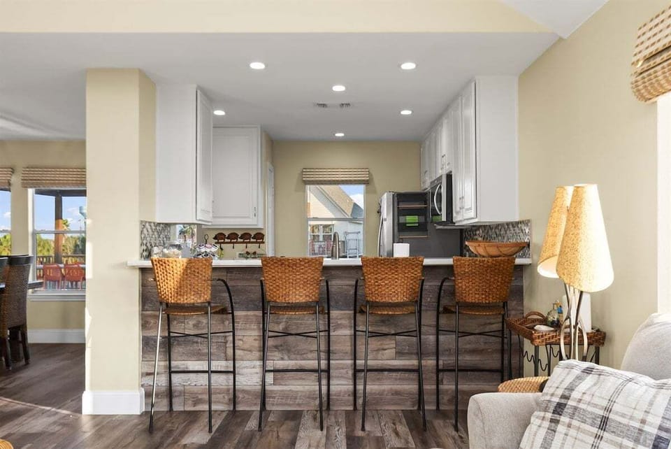 Spacious kitchen with bar seating, granite countertops, and open layout for entertaining.