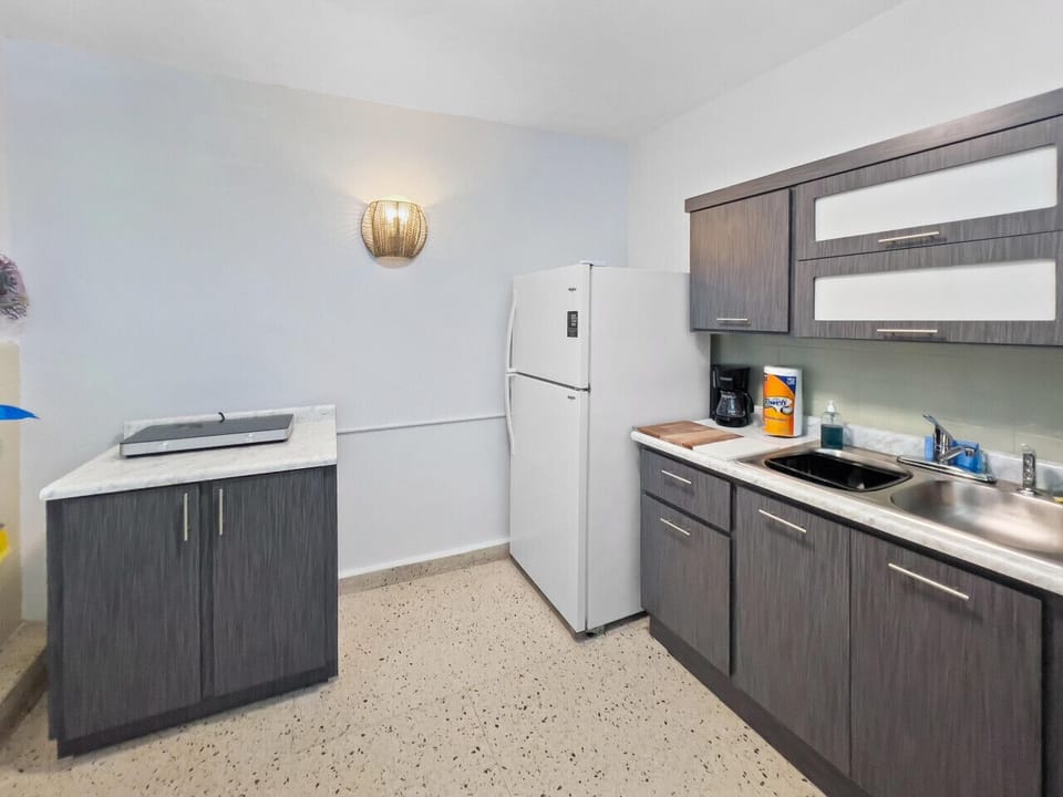 Cook with ease in a stylish kitchen where practical layout and soft lighting create a peaceful atmosphere