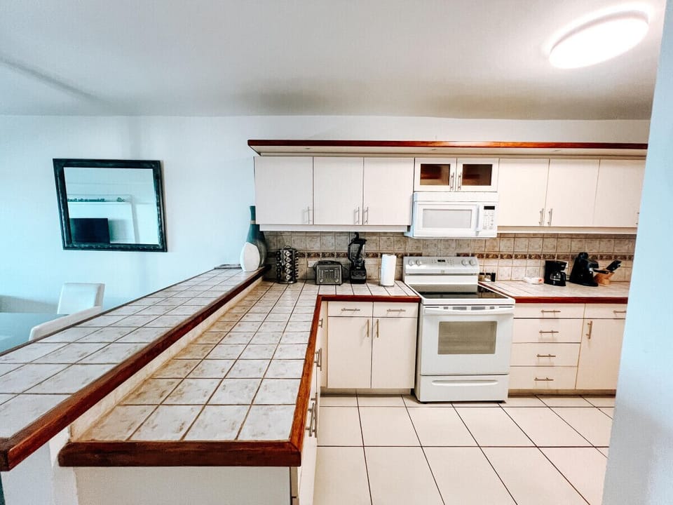 A spacious, well-stocked kitchen with everything needed for preparing meals, from modern appliances to ample counter space.