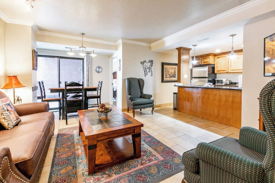 Living Room w/ Sleeper Sofa and Kitchen