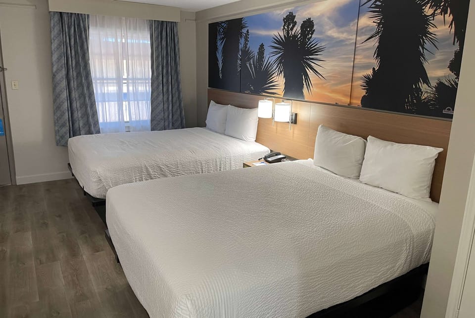 Deluxe Room, 2 Queen Beds, Non Smoking | Desk, laptop workspace, blackout drapes, iron/ironing board