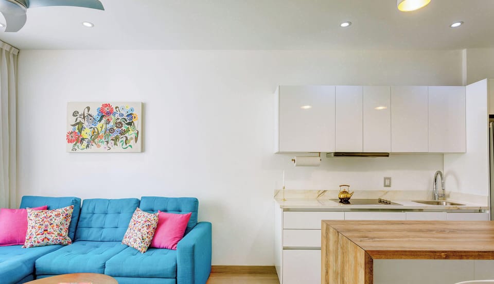 A comfortable sofa and a fully equipped kitchen