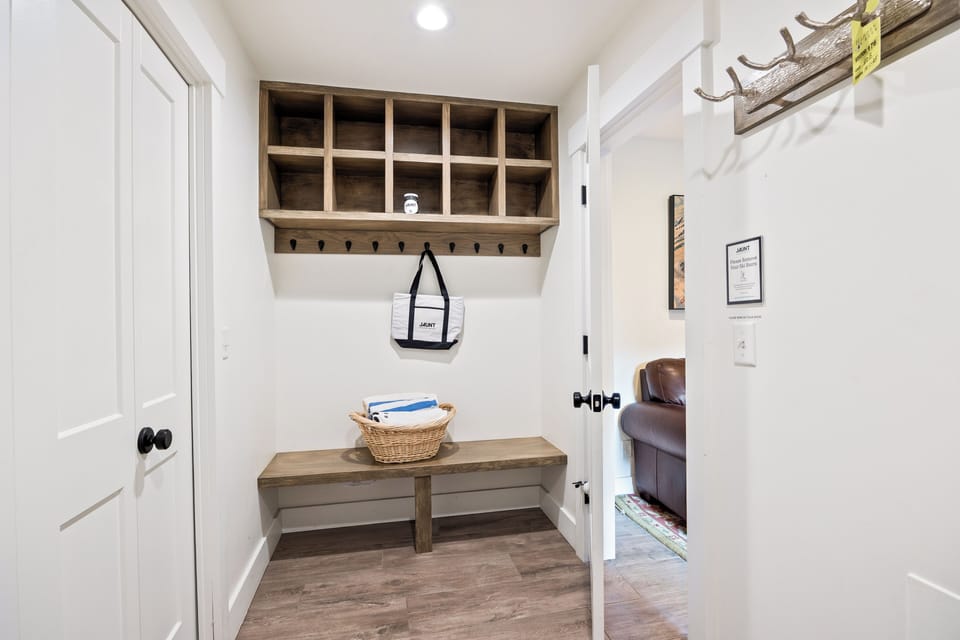 Welcoming mudroom area with built-in cubbies and hooks, perfect for storing coats, boots, and outdoor gear.