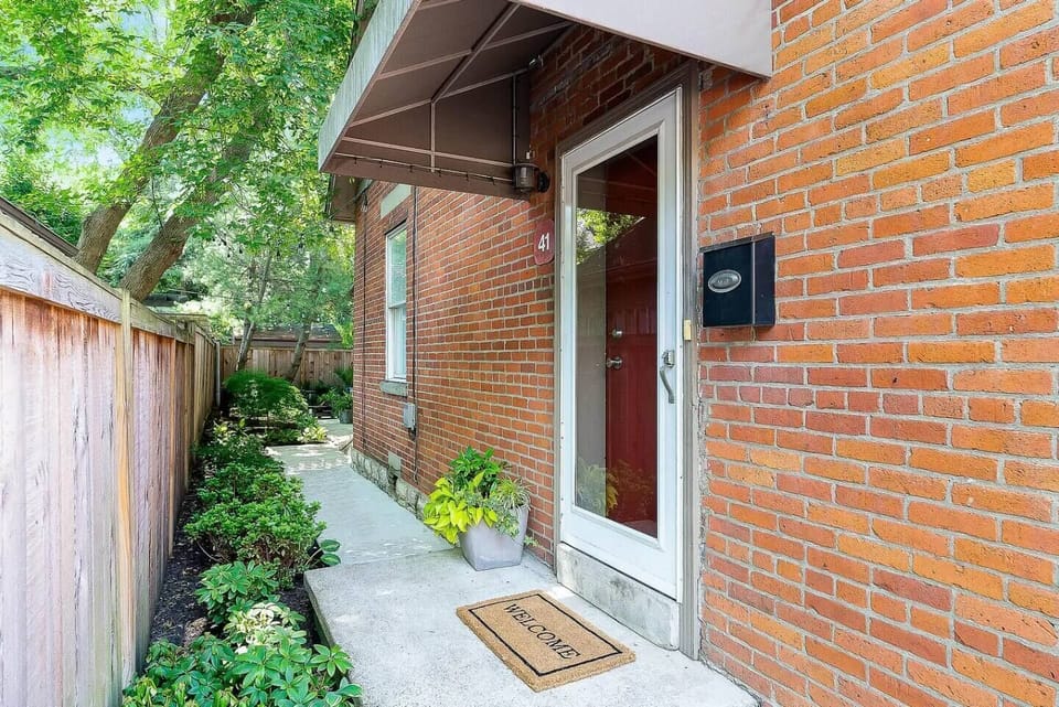 Entry from the street is through the wrought iron gate and walk to the back door.