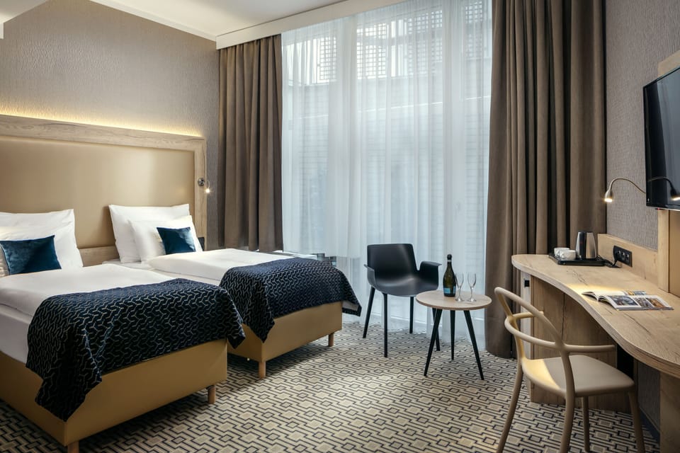 Standard Double or Twin Room | Minibar, in-room safe, desk, laptop workspace