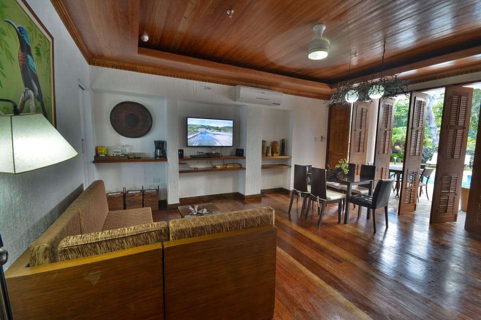 Three-Bedroom Suite - Beachfront View with Balcony | Living area | 32-inch Smart TV with satellite channels, books
