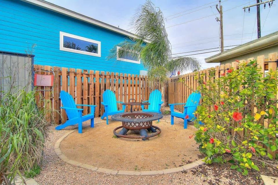 the amazing outdoor space which includes a large covered deck with dining table, patio furniture, as well as a fire pit for night time enjoyment.