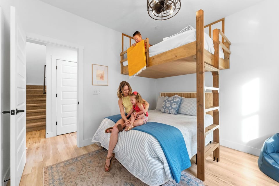 A fun bunk room with a queen bed and loft bed, perfect for families.