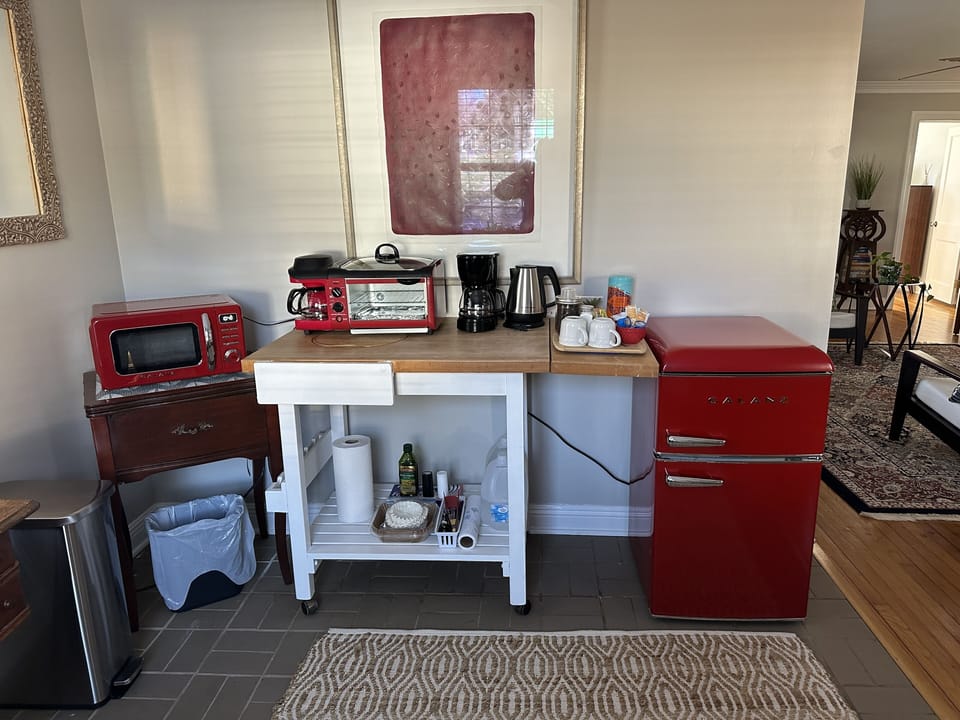 Retro kitchenette. Refrigerator, toaster, coffee maker, microwave, hot tea pot.
