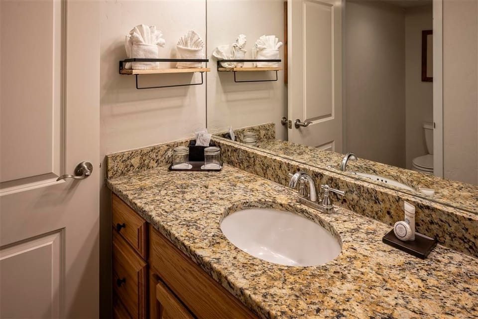 Freshen up in the modern bathroom with granite vanity.