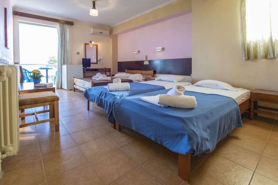Quadruple Room, Beach View | Iron/ironing board, free cribs/infant beds, bed sheets