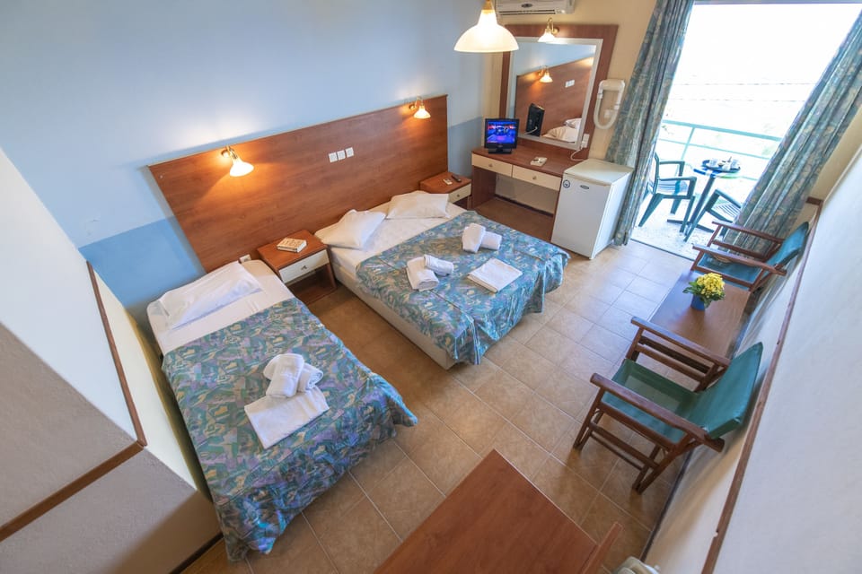 Triple Room, Beach View | Desk, iron/ironing board, free cribs/infant beds, bed sheets