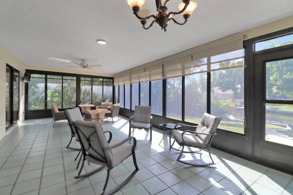 A Roku TV is mounted in the corner of the enclosed lanai.