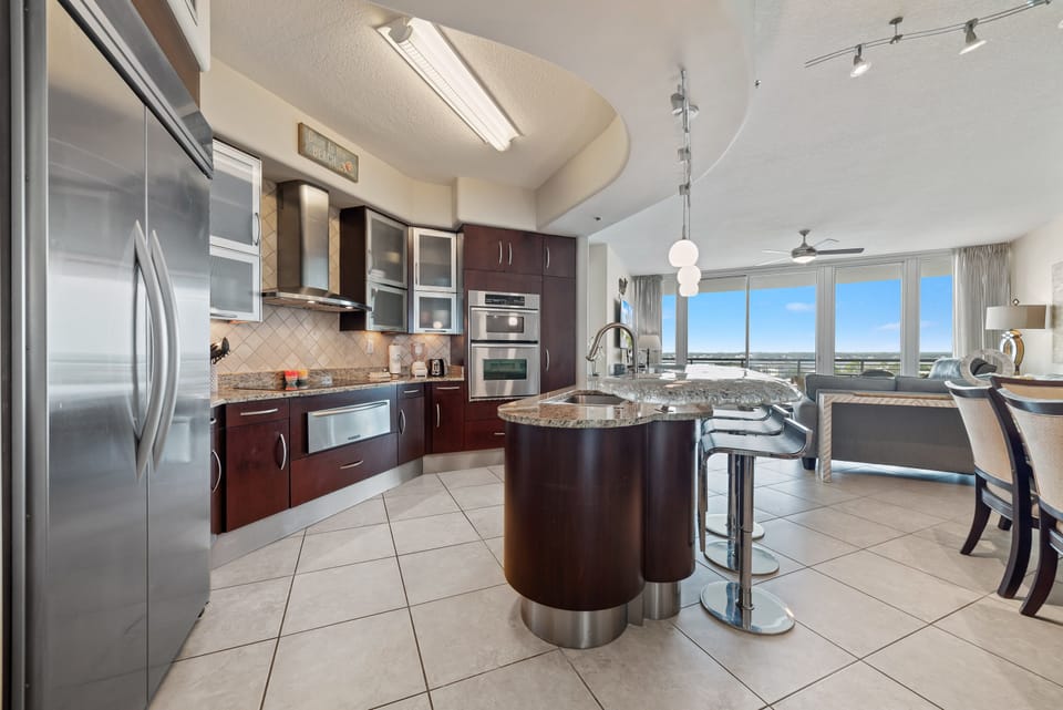 This well-designed kitchen boasts rich wood cabinetry, granite countertops, and stainless steel accents. The open layout ensures a seamless transition to the living and dining areas, creating a perfect space for gatherings.