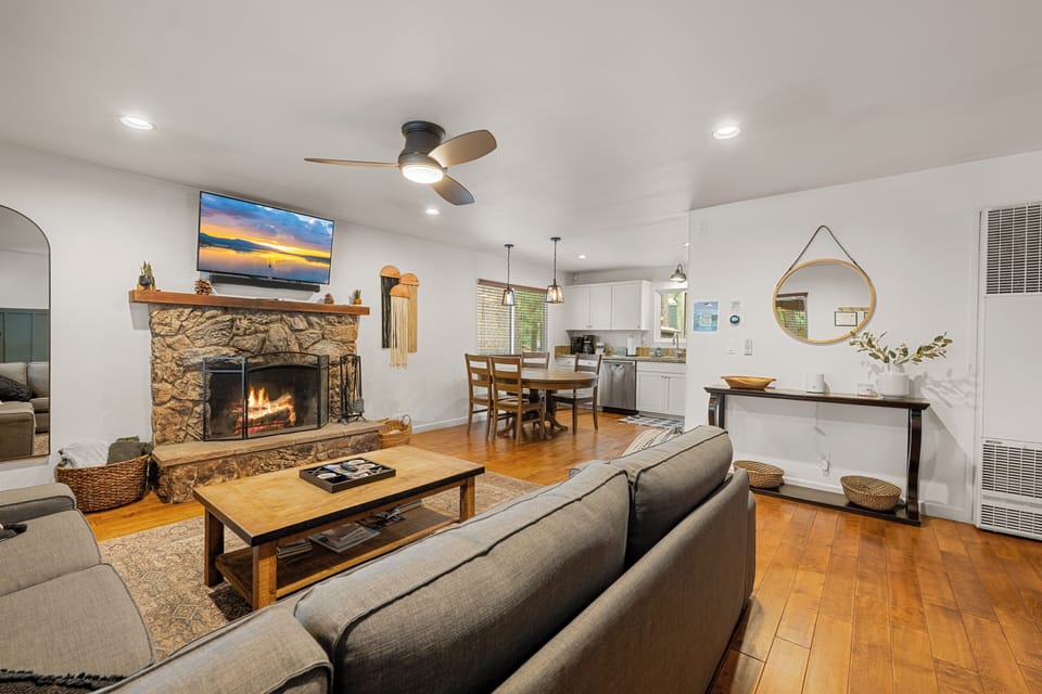 Living Room with Rock Fireplace - Living room area with rock fireplace is complete with a sectional sofa & flat-screen TV to allow everyone to kick back in style.