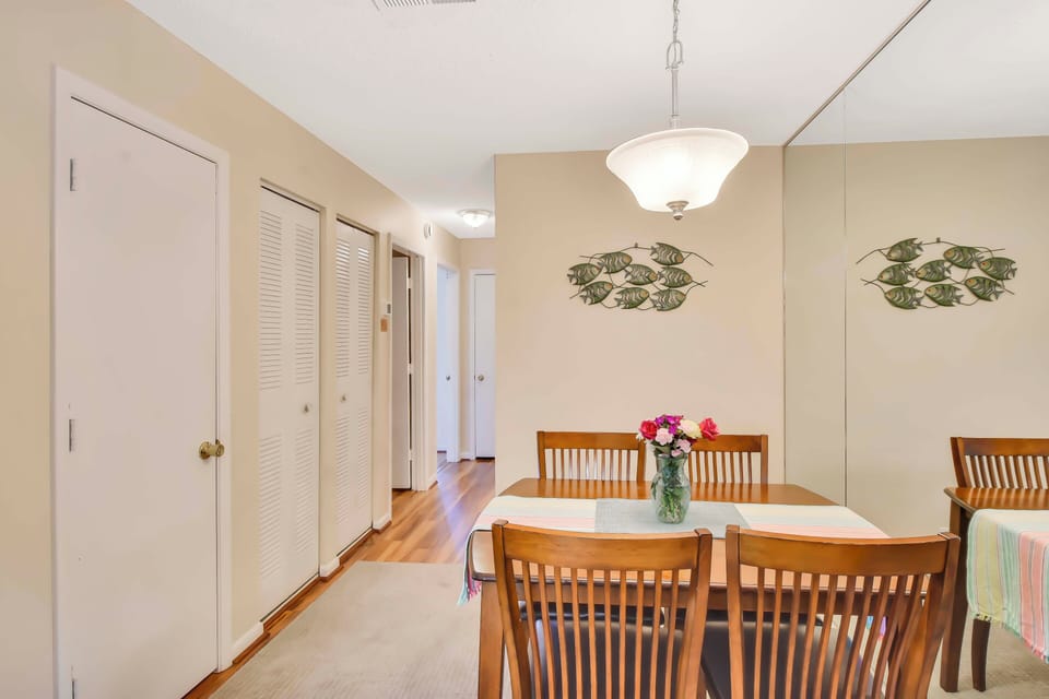 Dining Area with Mirror Accent Wall - Refined but unfussy, this dining nook reflects natural light and vacation vibes—perfect for shrimp boils, game nights, or a quick morning bite.
