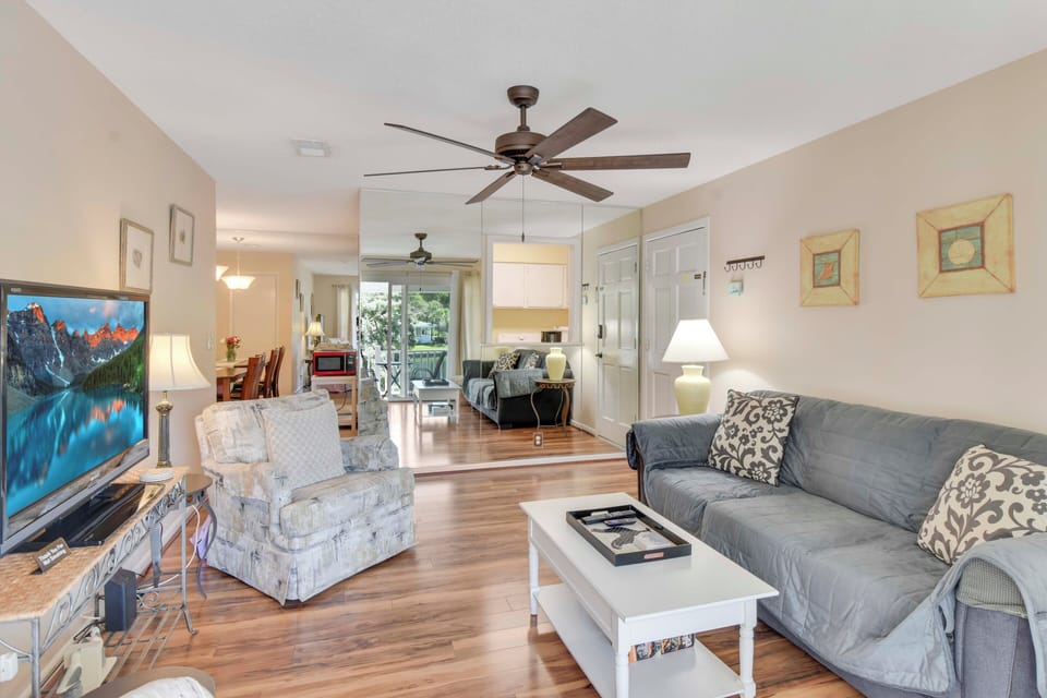 Living Room with Patio and Pond Views - Slide open the glass doors and let the outside in—this second-floor living room opens to your private balcony and a front-row seat to Ocean Walk’s lakeside calm.