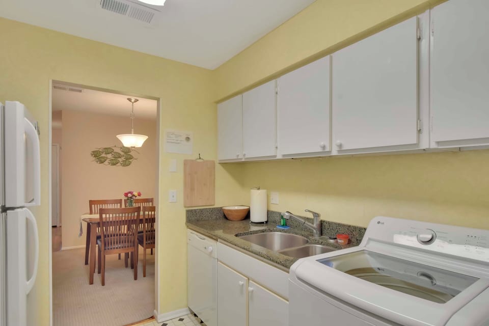 Kitchen with Coffee Station and Microwave - This reverse view of the kitchen shows the coffee maker, microwave, refrigerator, and granite counters, ready for morning brews and home-cooked meals.