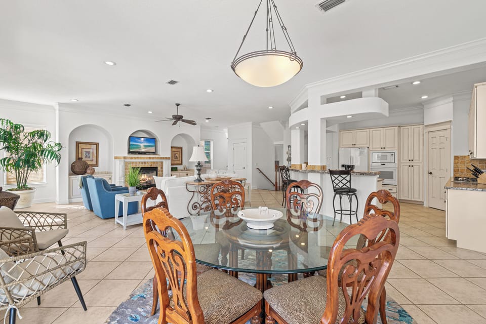 Your spacious open-concept living blends dining, kitchen, and lounge areas with coastal elegance and warm wood details.