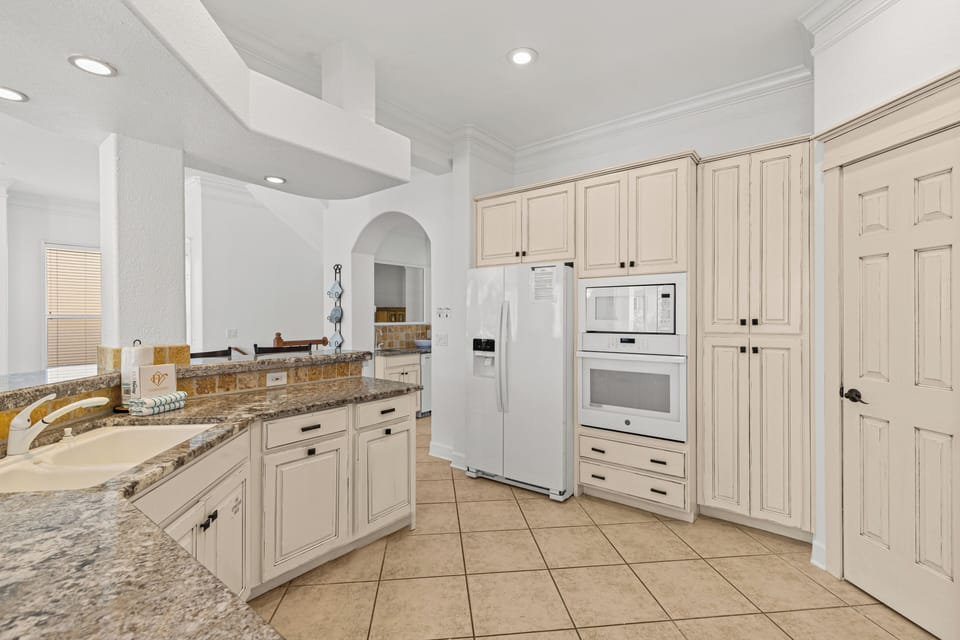 Cook in style with granite counters, cream cabinetry, and full appliances in your spacious kitchen sanctuary.