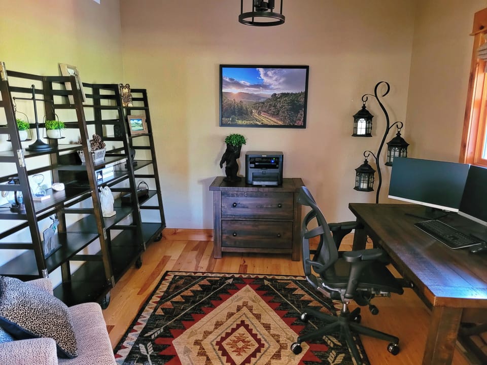 Office with desk, chair, monitor, and printer