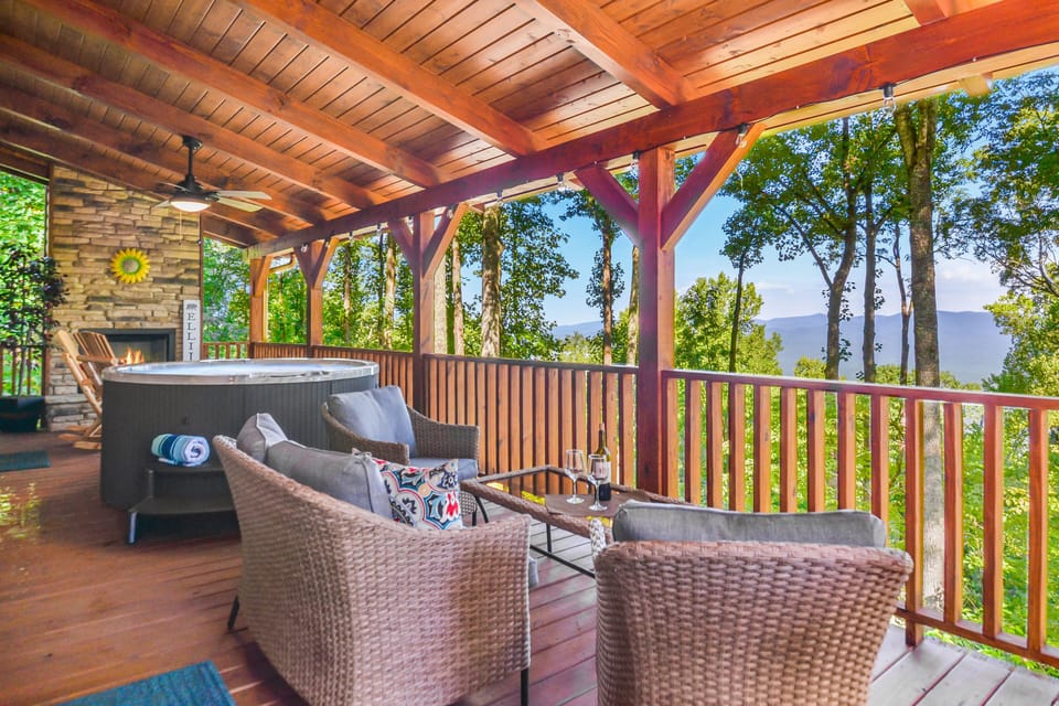 Expansive deck with hot tub outdoor fireplace, plenty of outdoor seating & grill