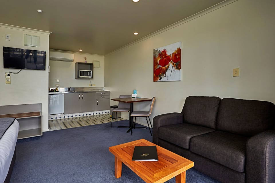 Deluxe Room, Partial Ocean View | Living area | 50-inch Smart TV with satellite channels, TV