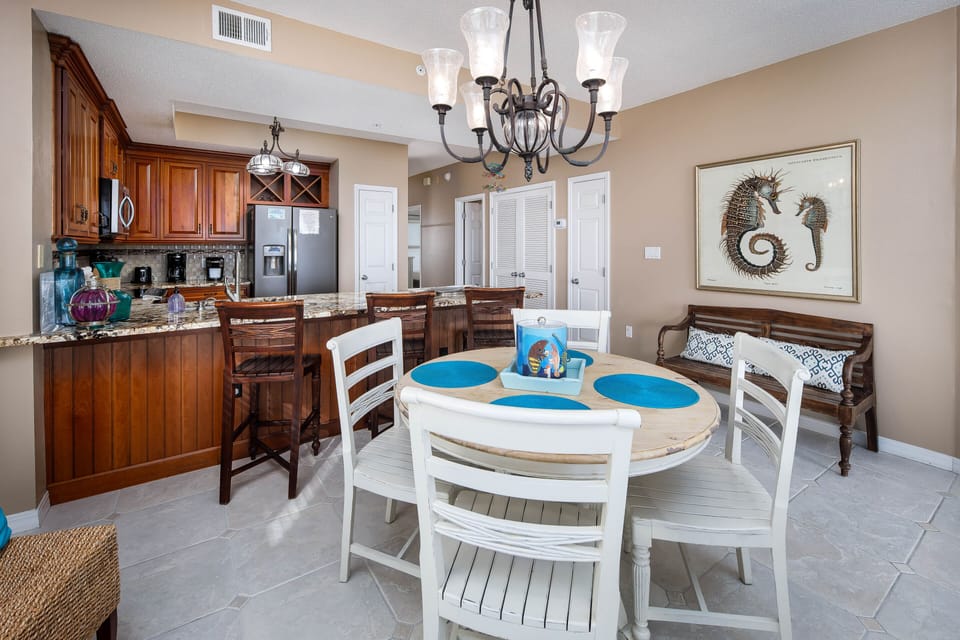DIning area - A 4 top table and extra seating at the countertop bar.