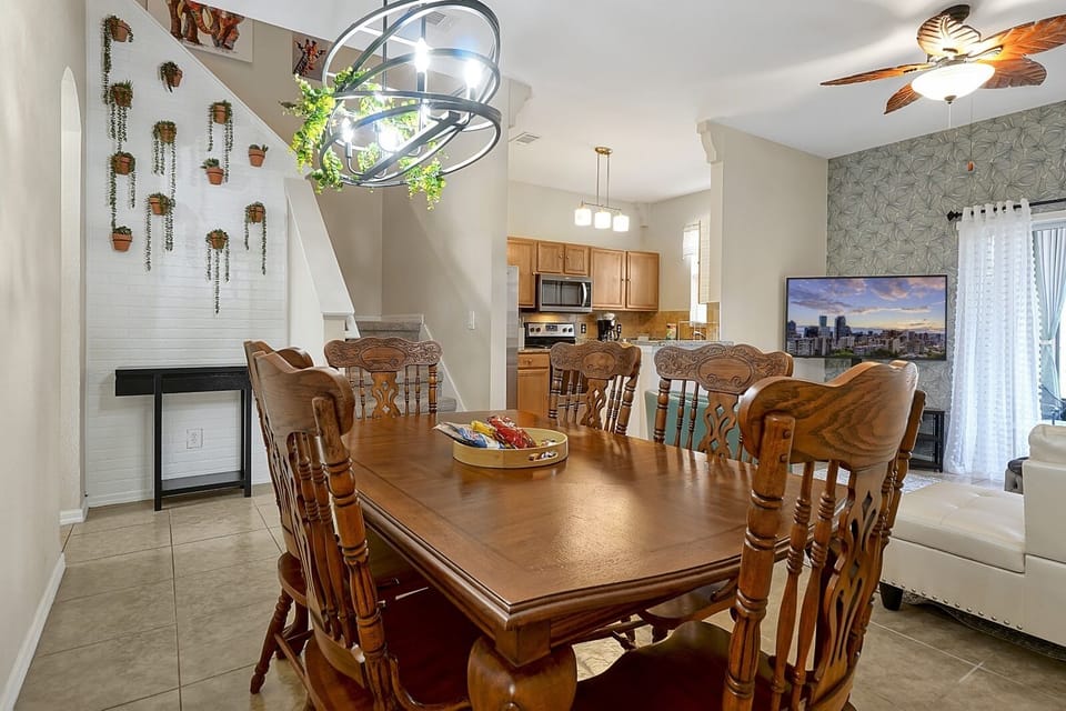 Elegant family dining. Gather around this beautiful wooden table for eight, set under a decorative modern chandelier for memorable vacation meals.