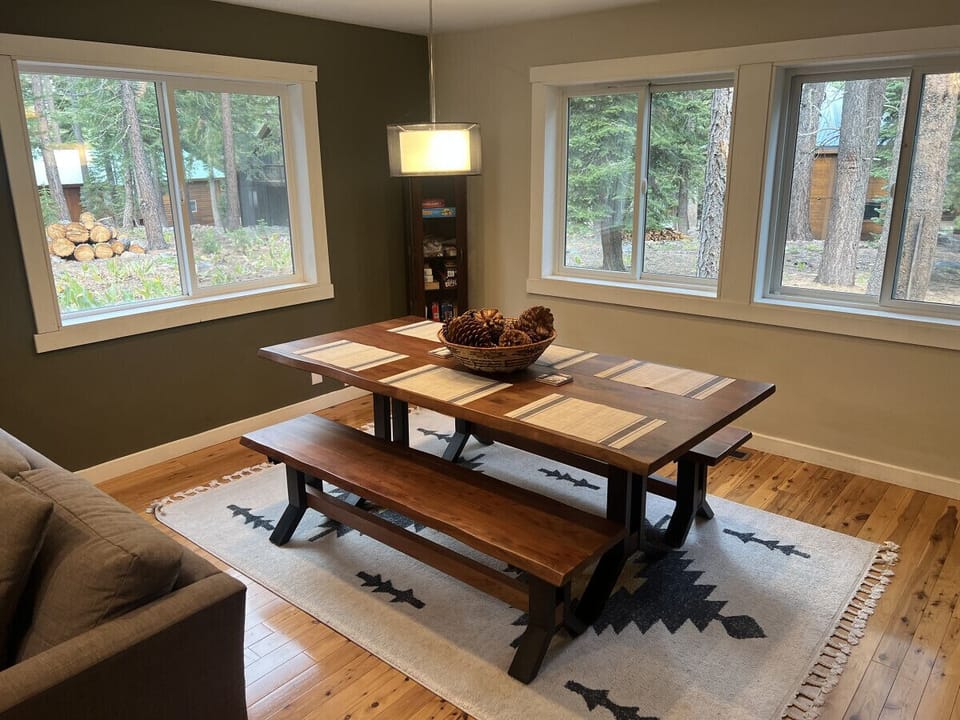 Downstairs Living Room with Sectional Sofa, wood stove, Large Smart TV and second dining area.