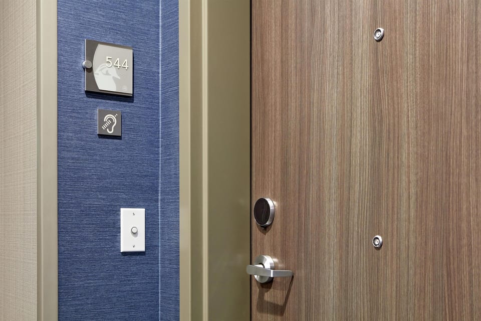 Hypo-allergenic bedding, desk, laptop workspace, blackout drapes