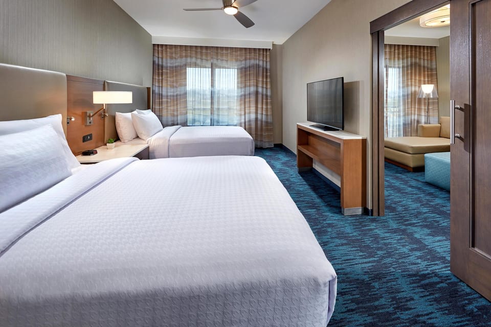 Hypo-allergenic bedding, desk, laptop workspace, blackout drapes